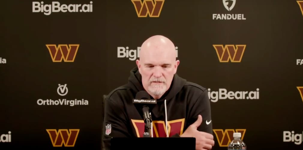 coach speaking with backdrop